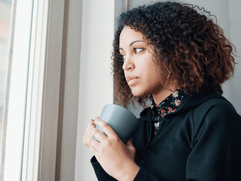 Woman Looking Out the Window